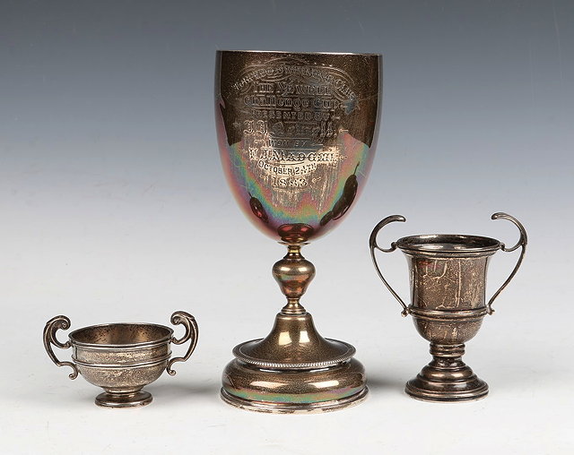 Appraisal: A SILVER TROPHY CUP standing on a stepped foot with