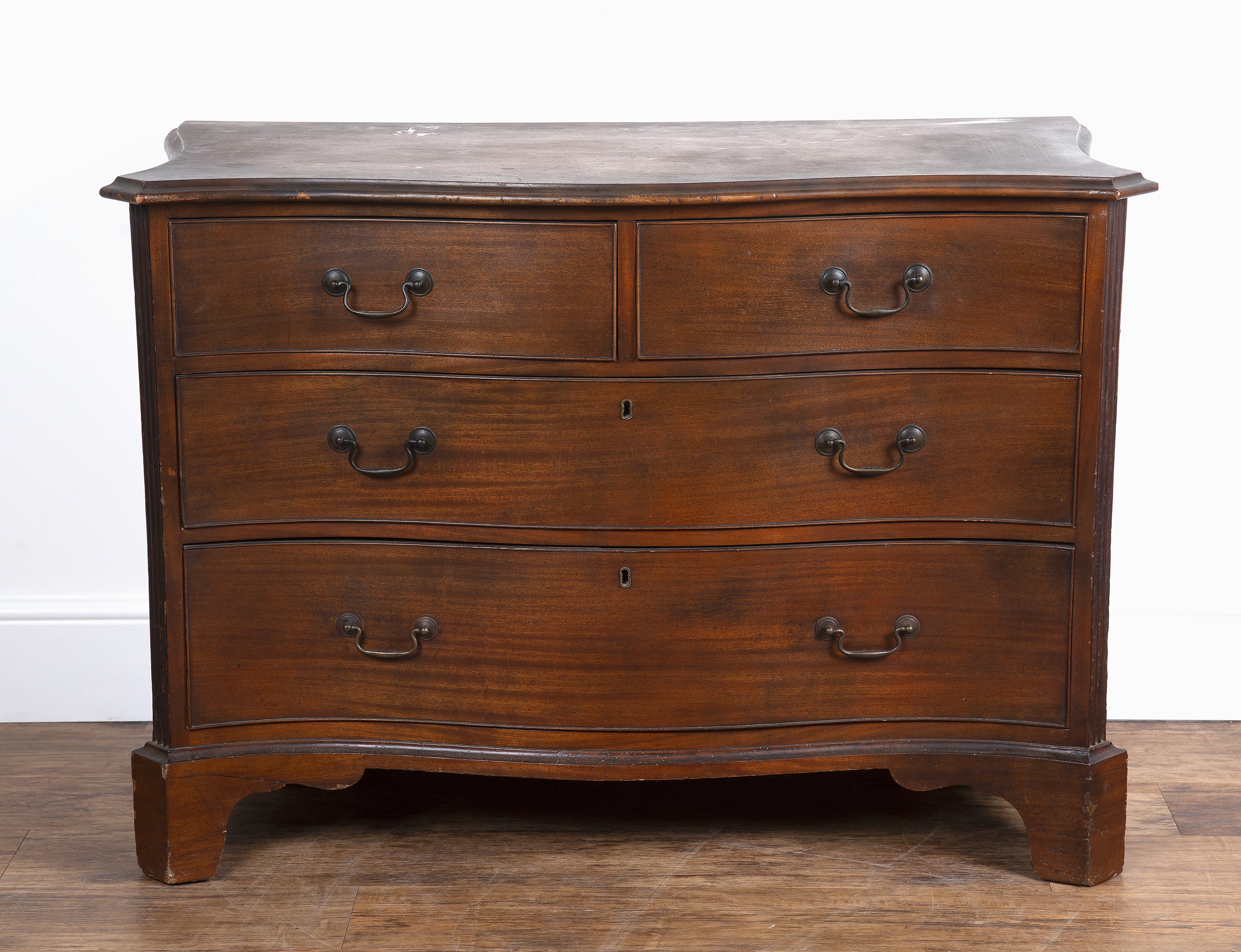 Appraisal: Mahogany serpentine chest th Century fitted three drawers with brass