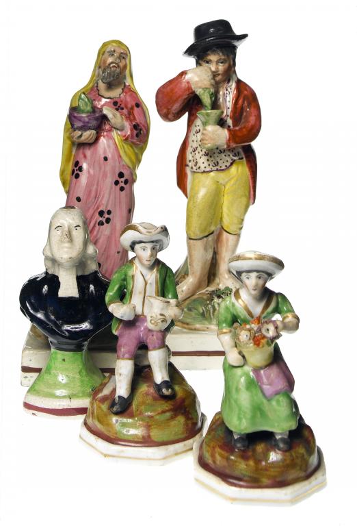 Appraisal: A PAIR OF STAFFORDSHIRE PORCELANEOUS MINIATURE FIGURES of a seated