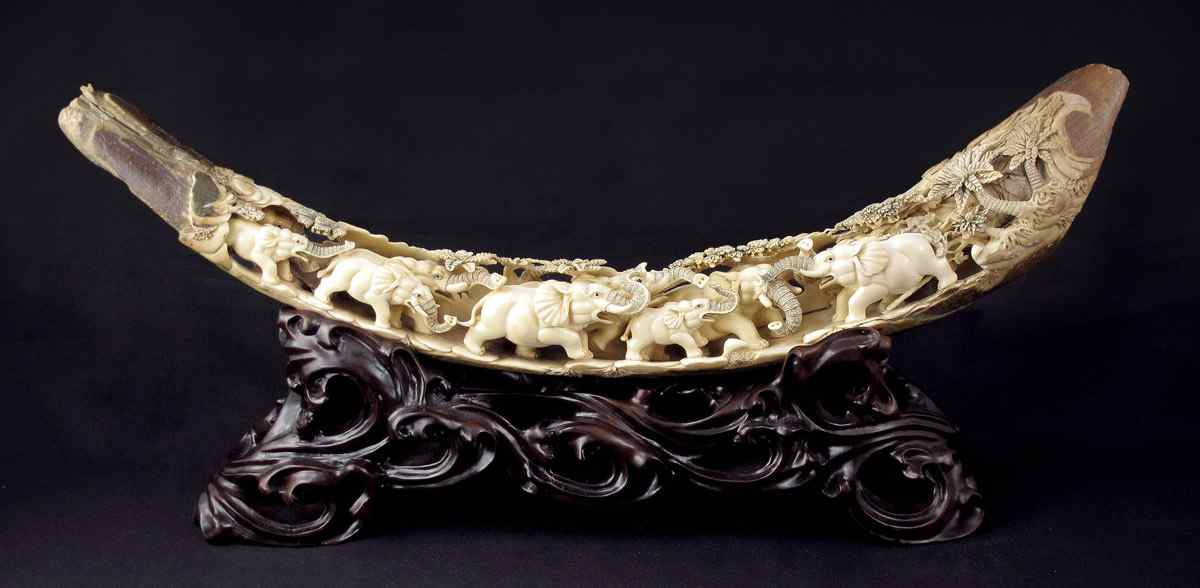 Appraisal: ORNATE CARVED MAMMOTH IVORY TUSK Ornately carved with elephants and