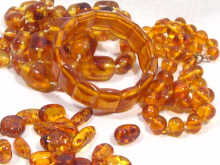 Appraisal: An amber expanding bracelet together with two amber bead necklaces