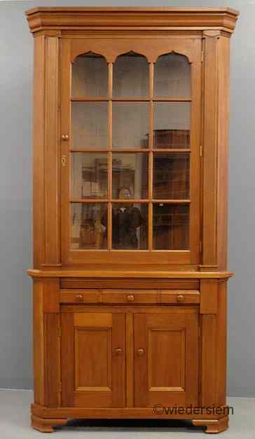 Appraisal: Pennsylvania style walnut two-piece corner cupboard late th c with