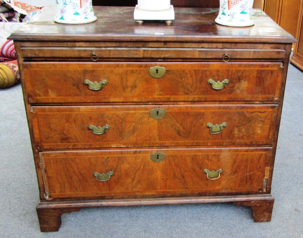 Appraisal: An th century figured walnut chest the brushing slide over