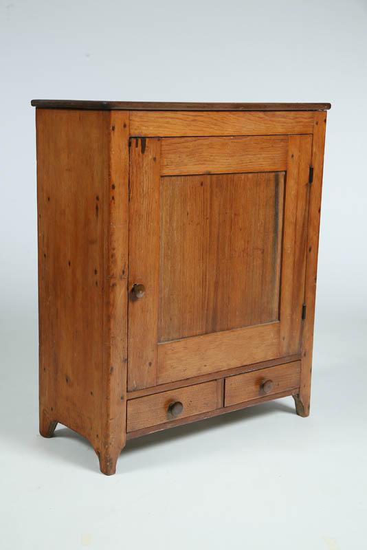 Appraisal: SMALL CUPBOARD Walnut with a paneled door interior pigeon holes