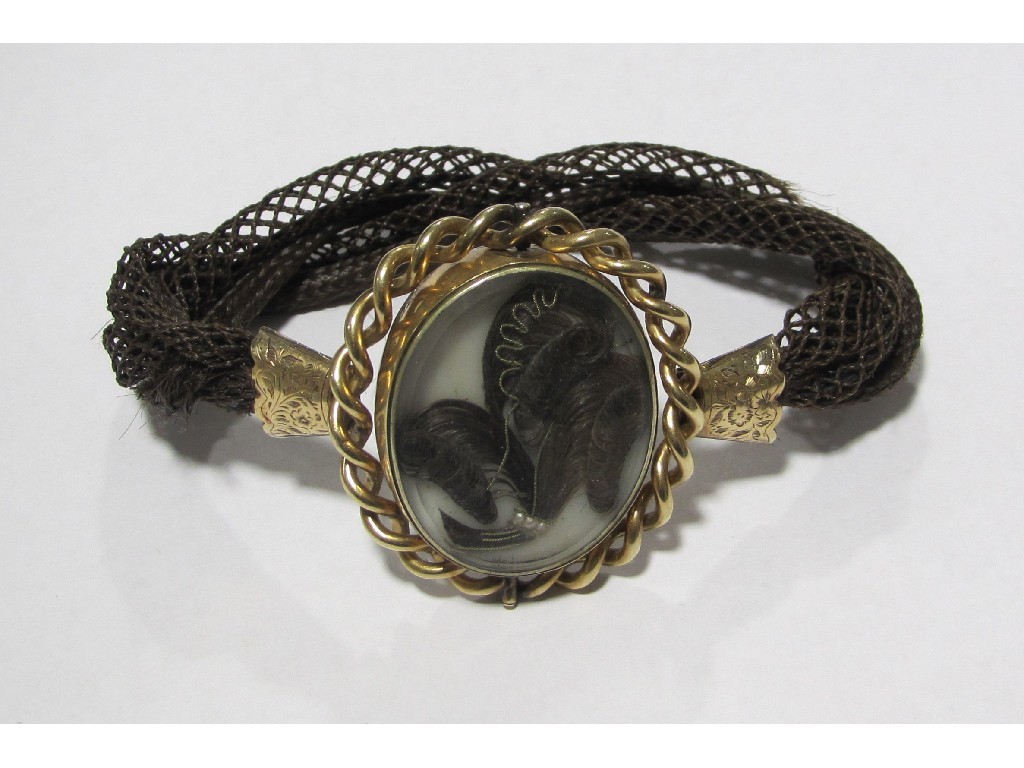 Appraisal: Victorian mourning bracelet with revolving hair locket within a rope