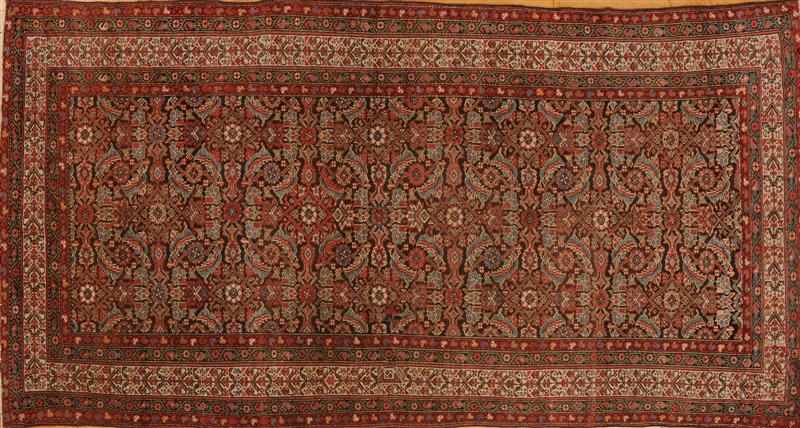 Appraisal: FERAGHAN LONG RUG The brown field worked with foliate trelliswork