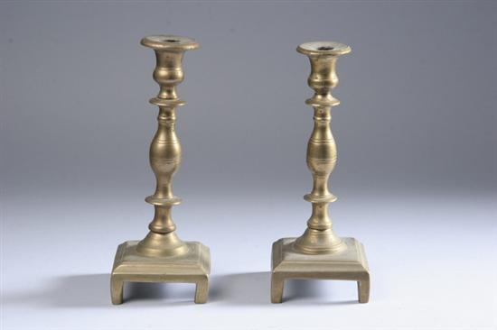 Appraisal: FOUR BRASS CANDLESTICKS One pair American baluster form on square