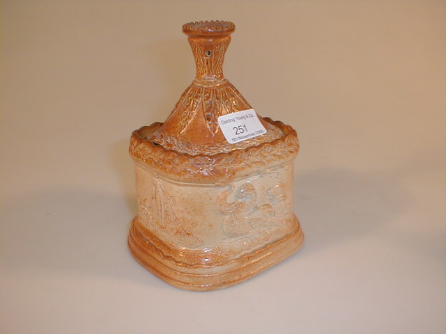 Appraisal: A thC saltglazed stoneware tobacco jar with taper sconce finial