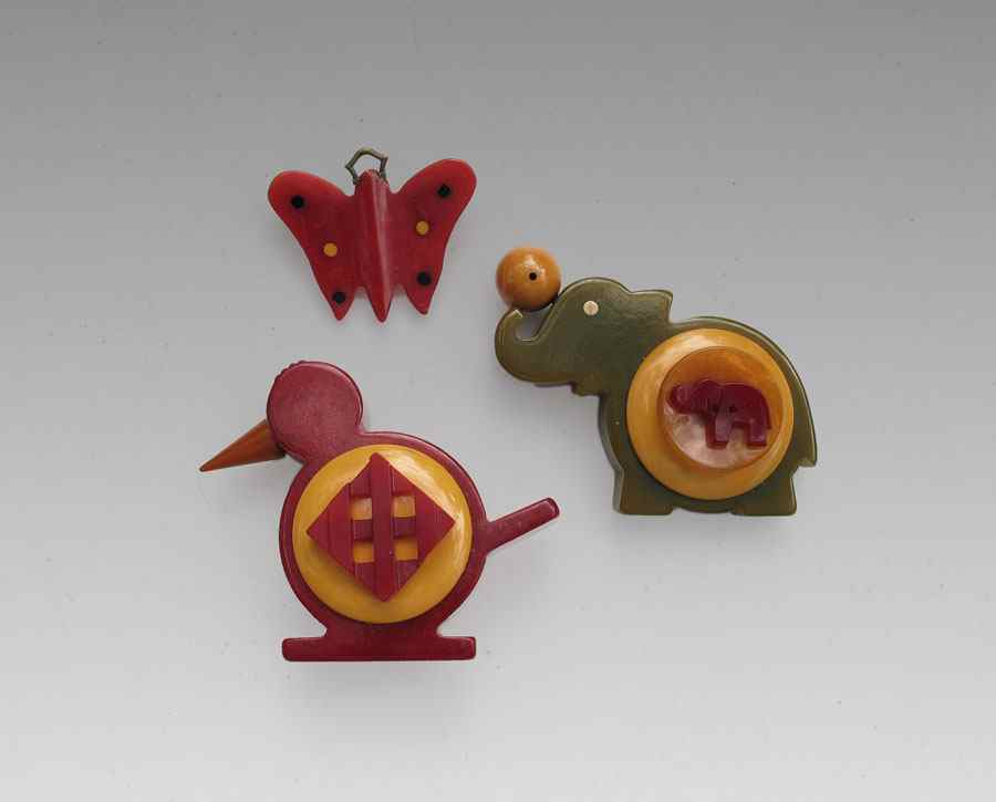 Appraisal: WHIMSICAL BAKELITE FIGURAL PINS Red bird cleverly made from the