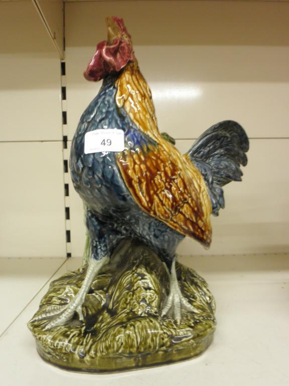 Appraisal: A French pottery cockerel shaped spill holder decorated with Majolica