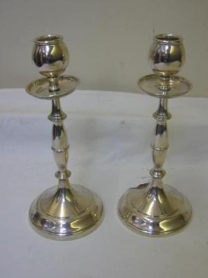 Appraisal: A PAIR OF CANDLESTICKS the knopped baluster stem issuing a