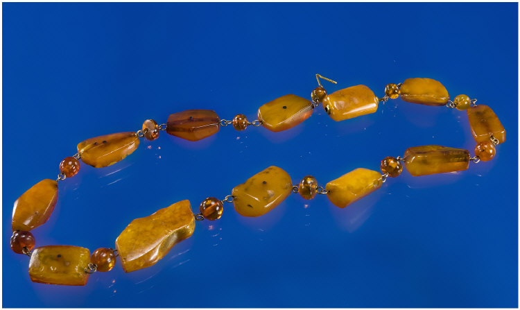 Appraisal: Honey Coloured Amber Necklace Comprising Twelve Free Form Amber Beads