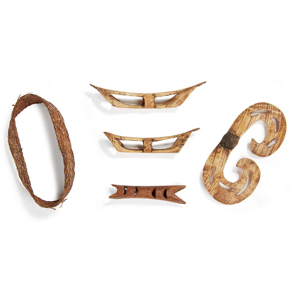 Appraisal: Asmat Nose Pieces and Armband Four Asmat shell nosepieces and