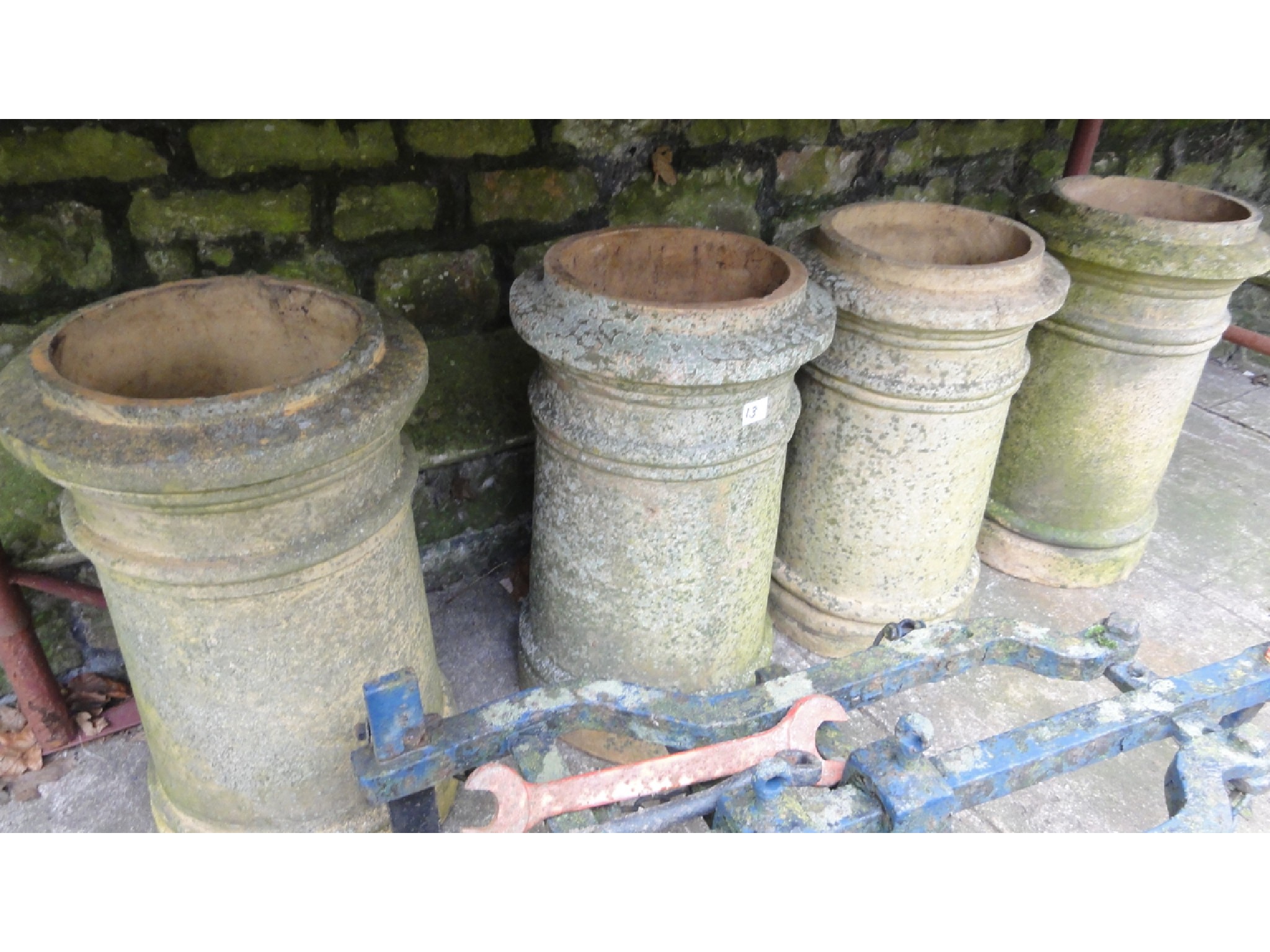 Appraisal: Four matching reclaimed buff coloured chimney pots of cylindrical form