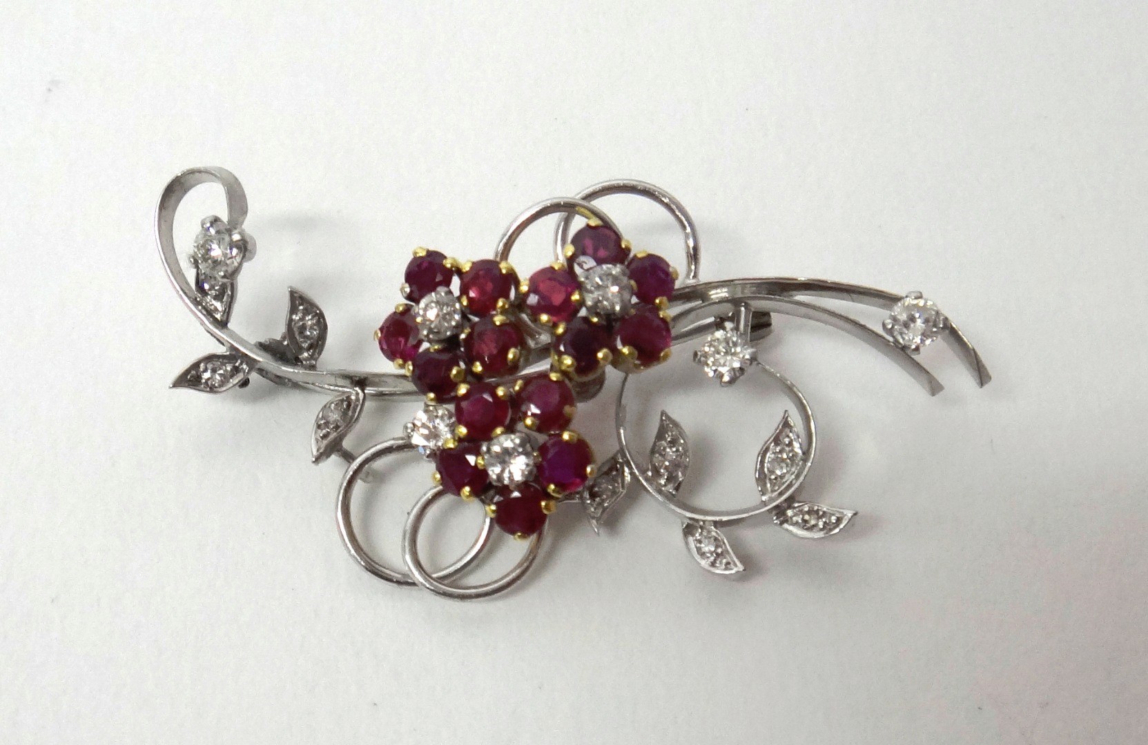 Appraisal: A diamond and ruby set brooch designed as a floral