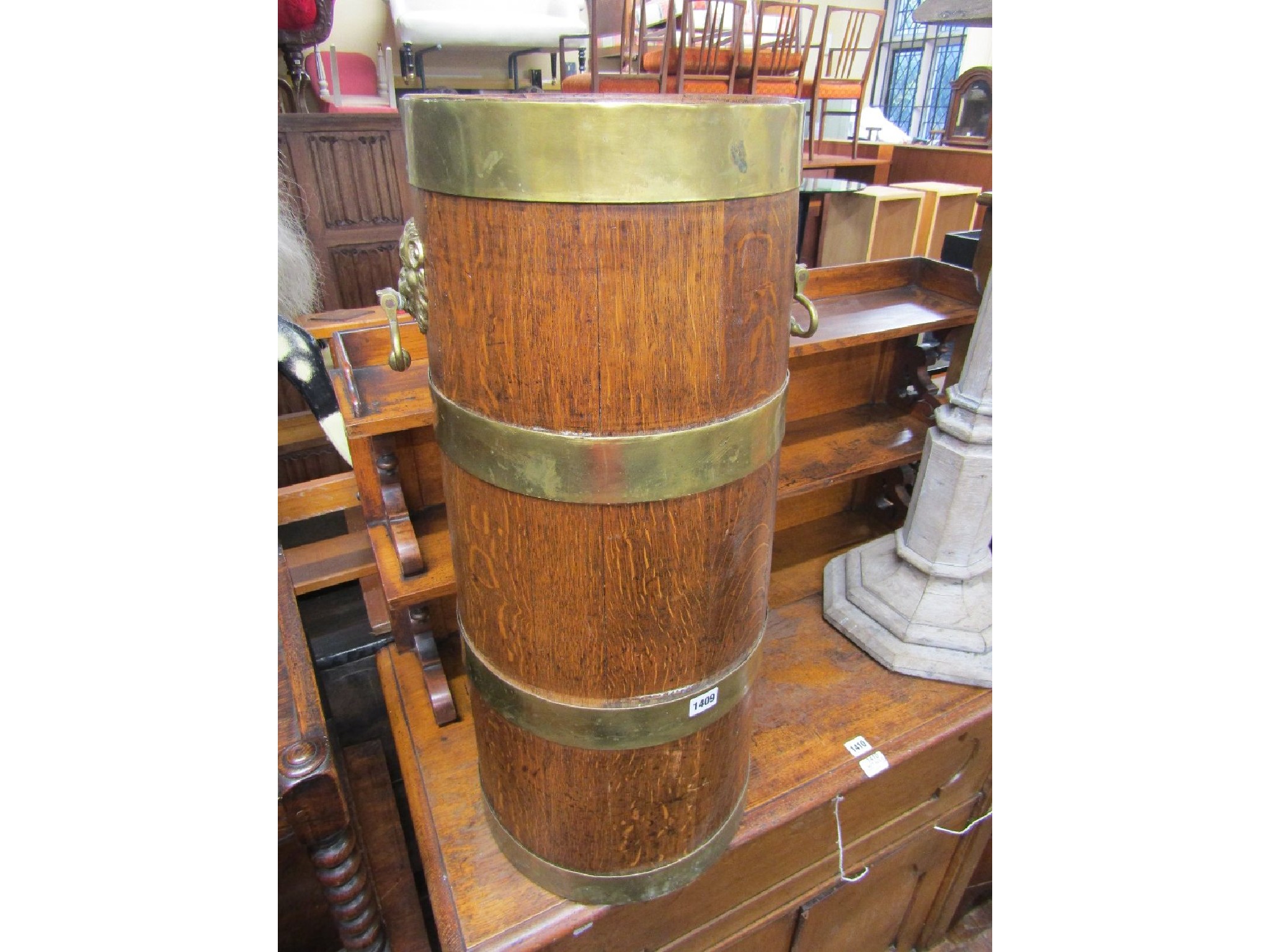 Appraisal: An Edwardian oak stick stand of cylindrical tapering form with