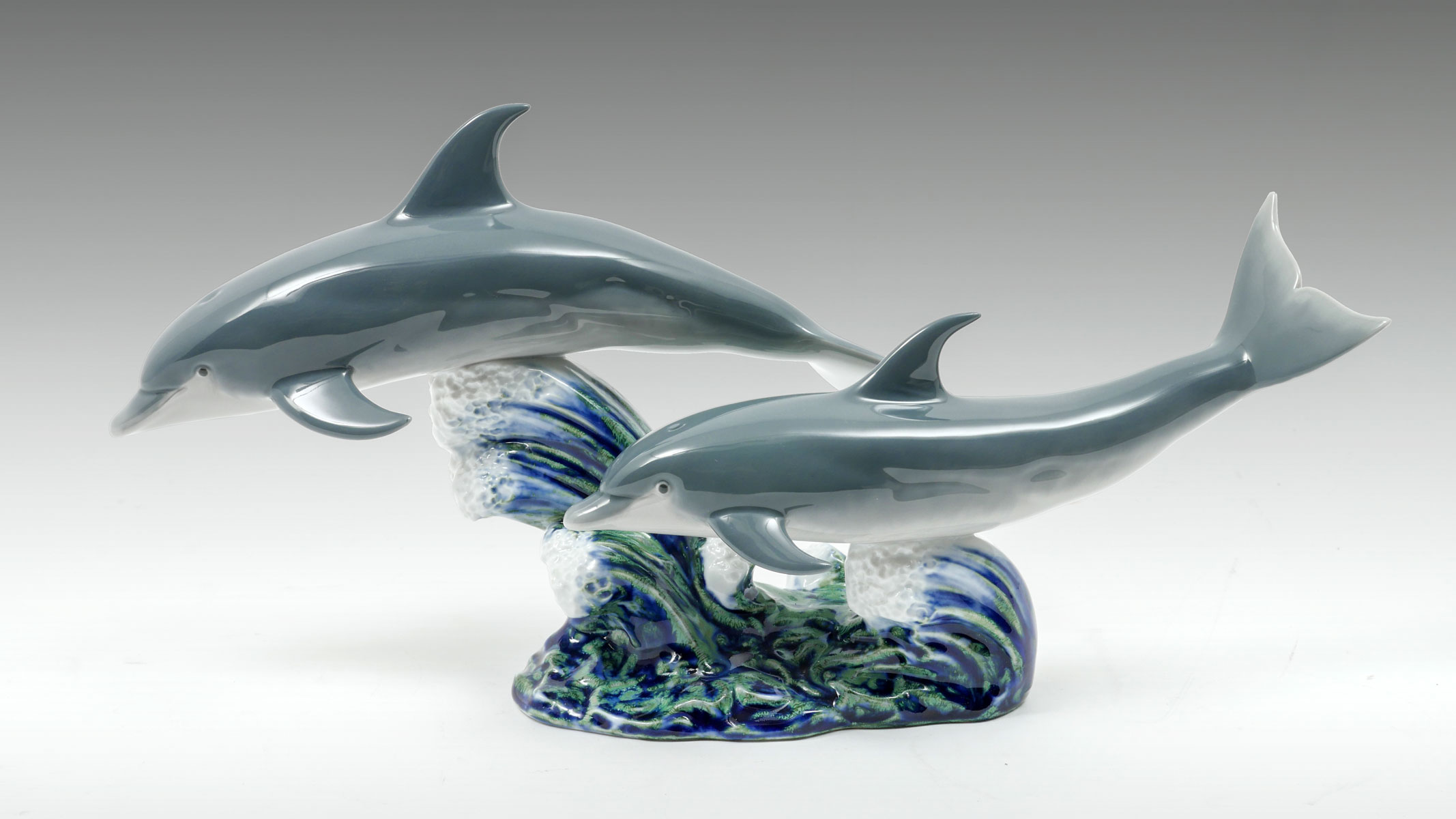 Appraisal: LLADRO PORCELAIN DOLPHINS Lladro porcelain dolphins playfully jumping out of