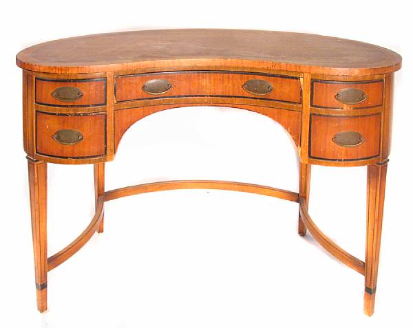 Appraisal: A satinwood kidney shaped writing desk together with a small