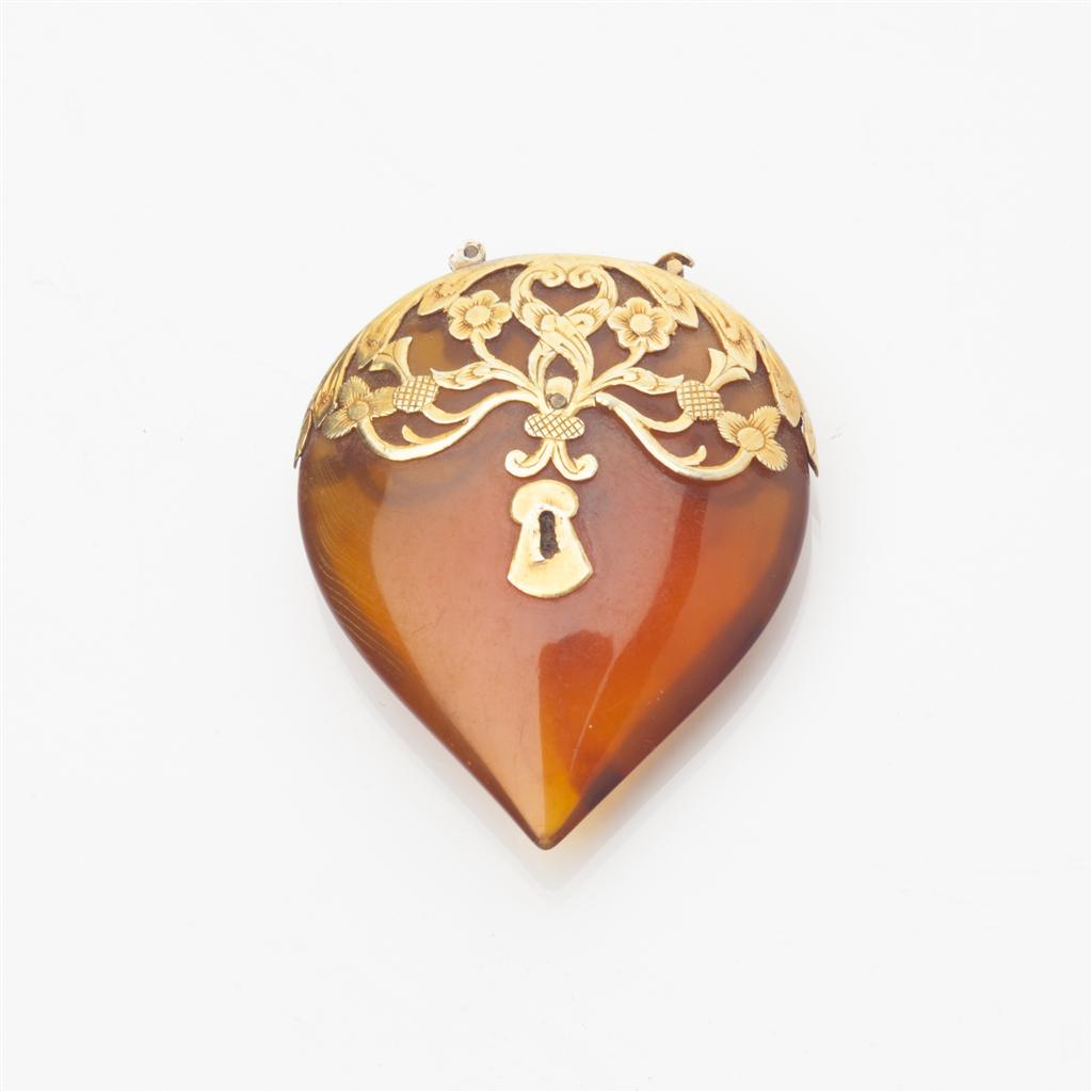 Appraisal: A Victorian gold mounted amber pendant modelled as a padlock