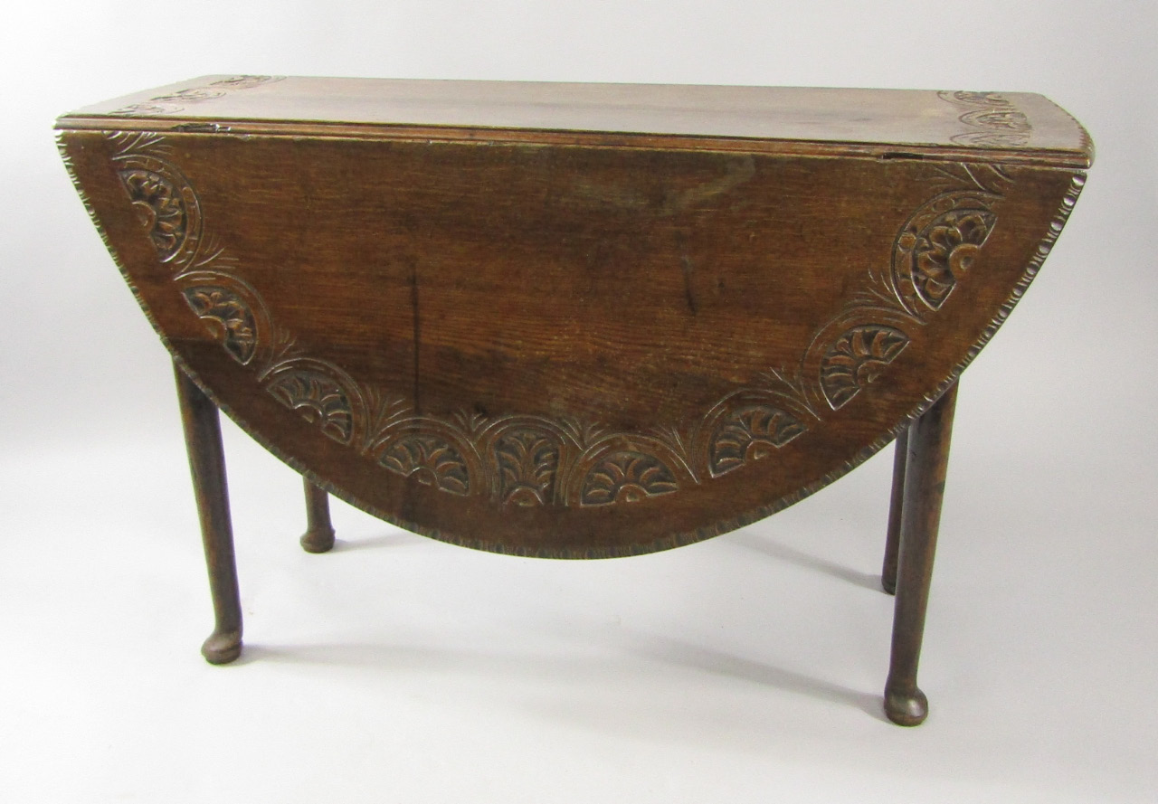 Appraisal: A George III oak dropleaf dining table the top carved