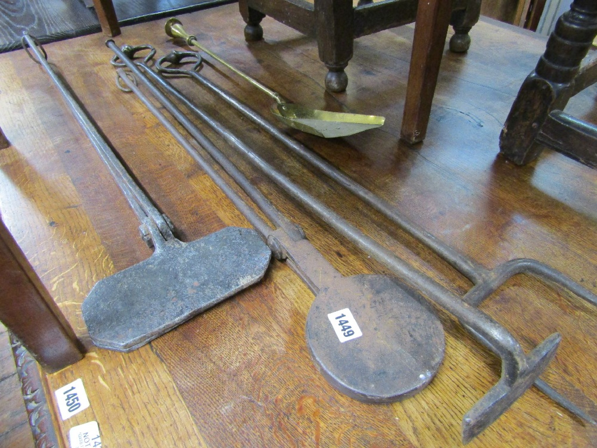 Appraisal: A collection of hand wrought country house fire irons including