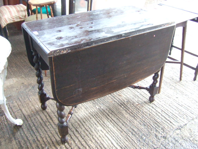 Appraisal: A mid th century oak drop flap dining table raised