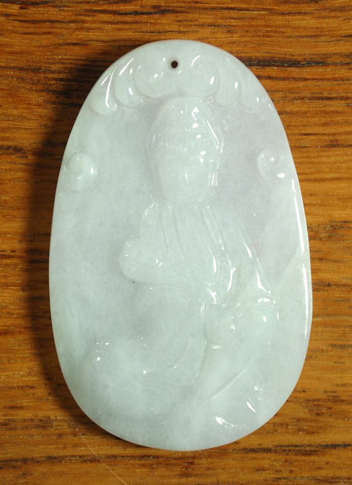 Appraisal: CARVED JADE PENDANT having a pale lavender and green color