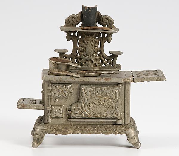 Appraisal: AN EAGLE CAST IRON TOY STOVE WITH ACCESSORIES American an