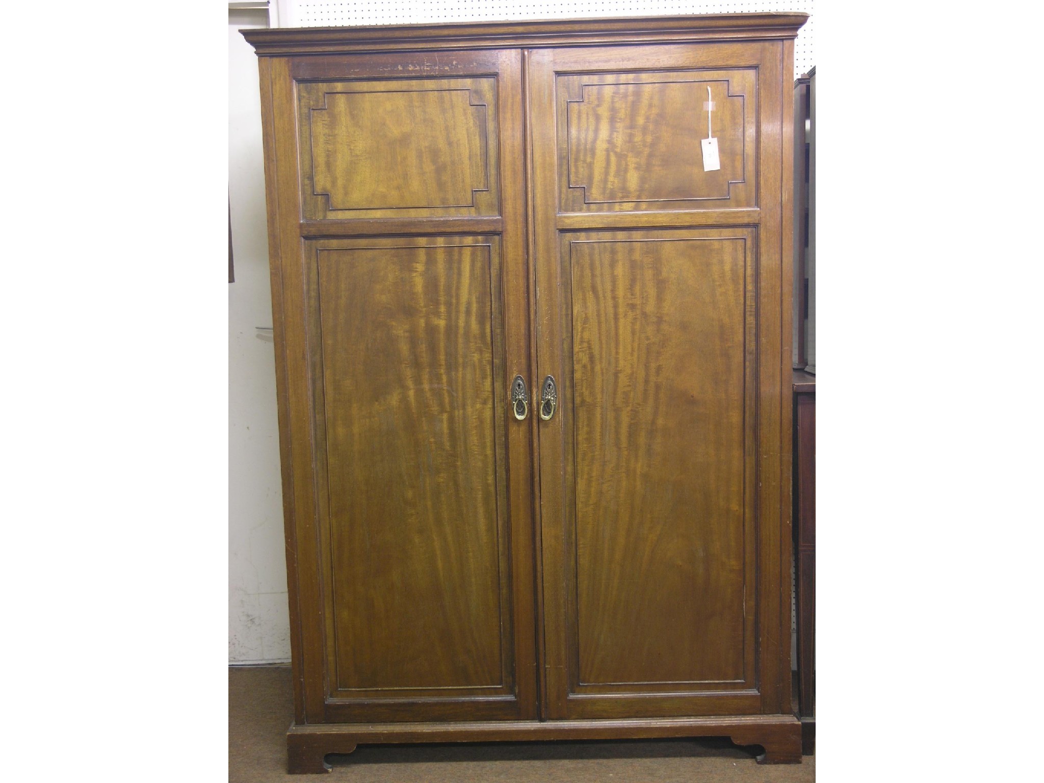 Appraisal: An early th century mahogany wardrobe enclosed by a pair