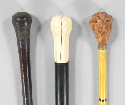 Appraisal: Three Antique Walking Sticks The first - L with carved