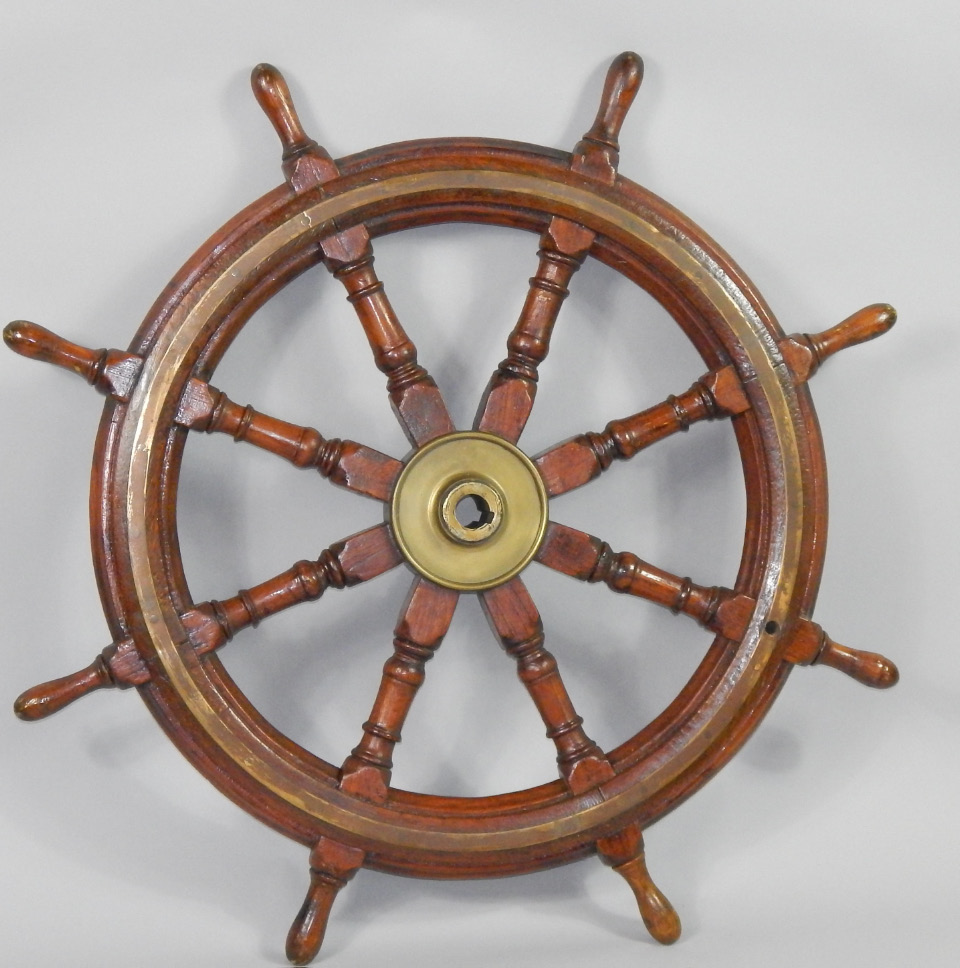 Appraisal: An oak and brass bound capstan wheel cm diameter