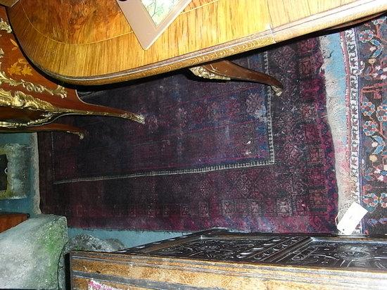 Appraisal: A BELUCH RED GROUND RUG x approx and a smaller