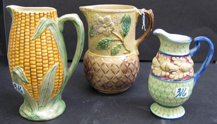 Appraisal: A GROUP OF THREE ENGLISH MAJOLICA GLAZED POTTERY PITCHERS -