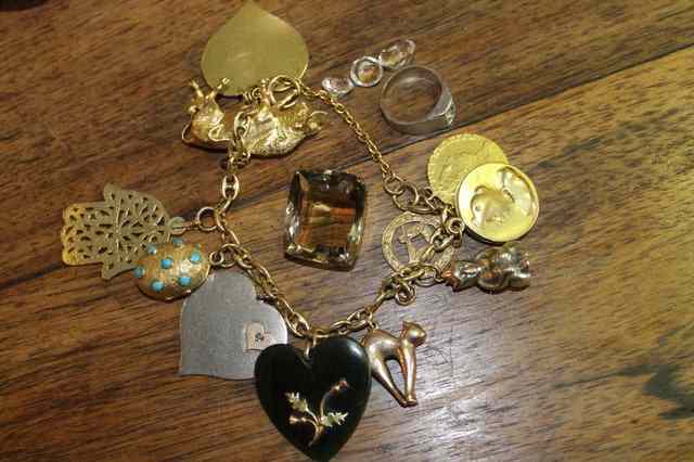 Appraisal: A CHARM BRACELET set with a number of gold and