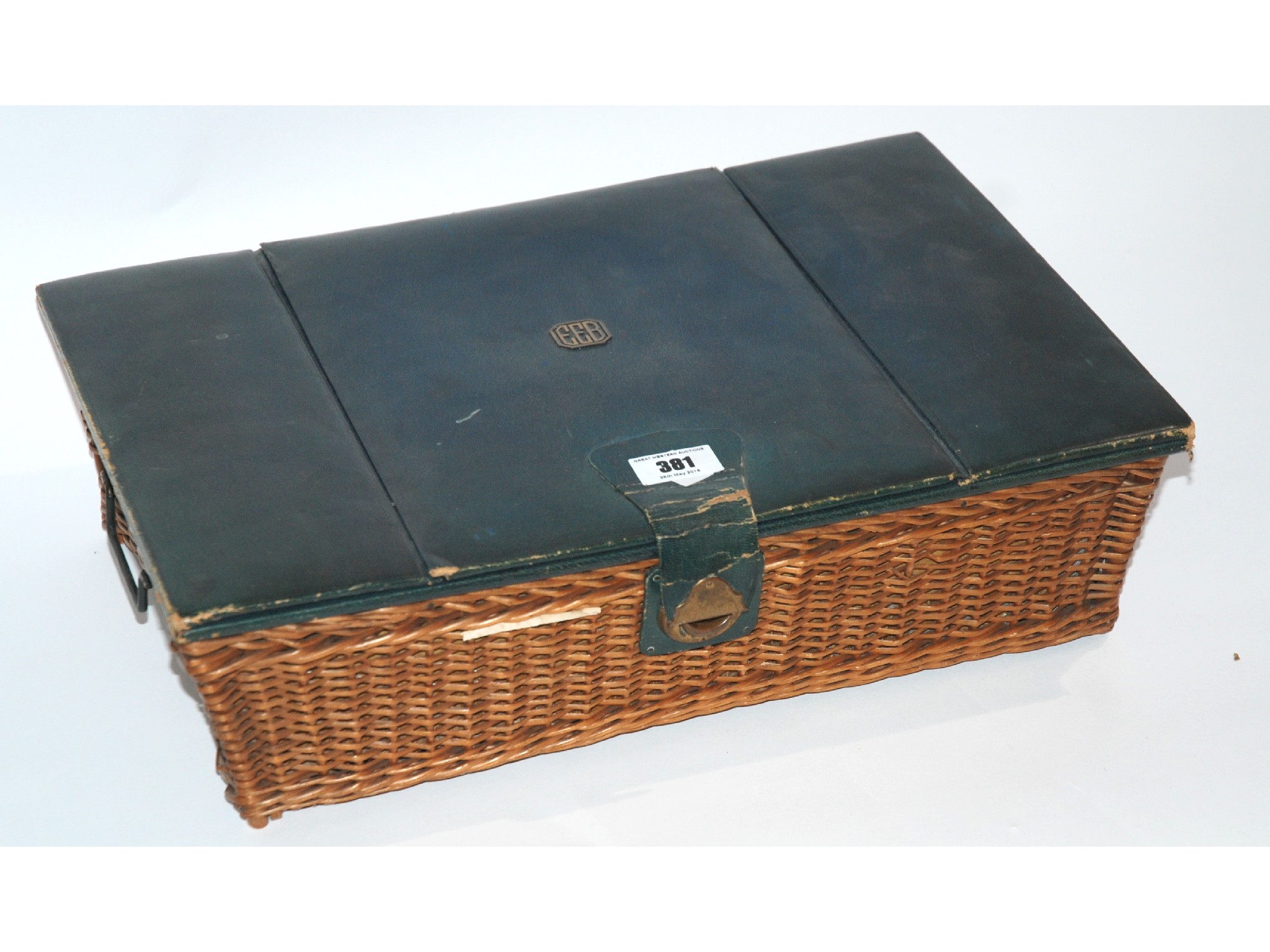 Appraisal: A wicker and leather topped sewing box with assorted contents