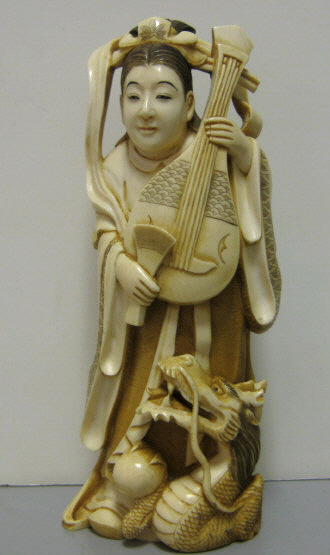 Appraisal: JAPANESE CARVED IVORY FIGURE Woman with lute and dragon light