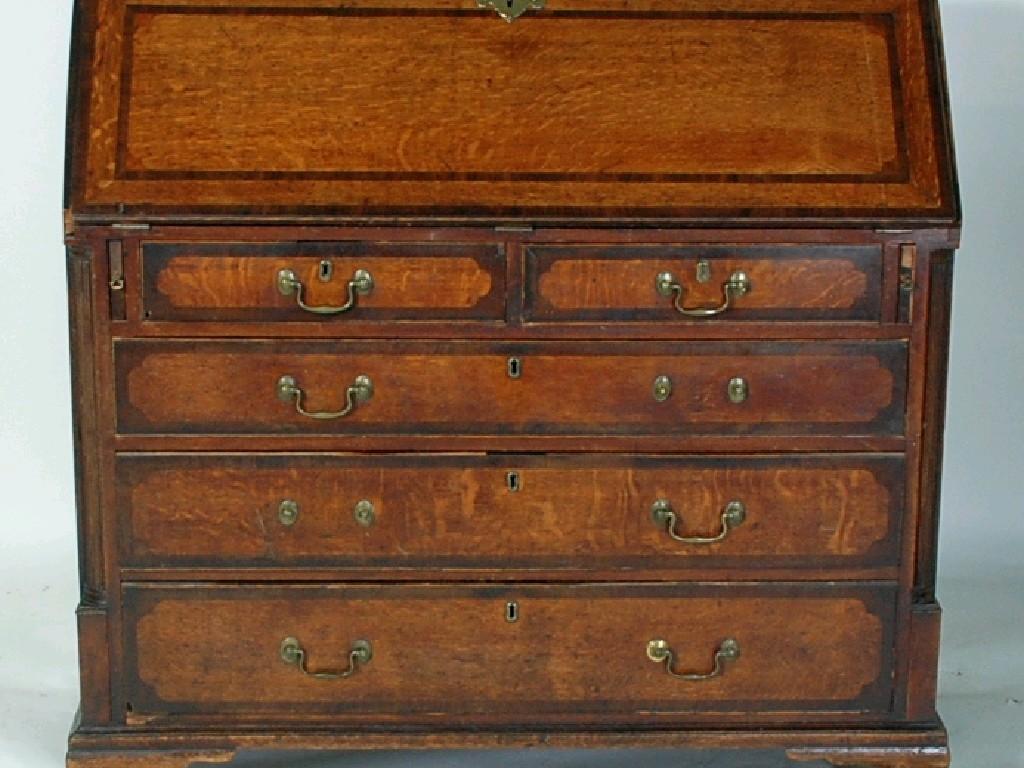 Appraisal: GEORGE III OAK AND MAHOGANY CROSSBANDED BUREAU the oblong top