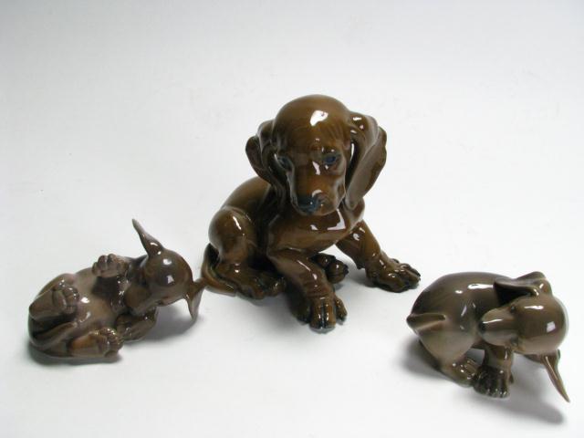 Appraisal: Group of Three Porcelain Dogs including two Royal Copenhagen playful