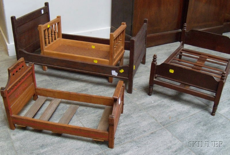 Appraisal: Four Stained Wood Doll Beds early th century various designs