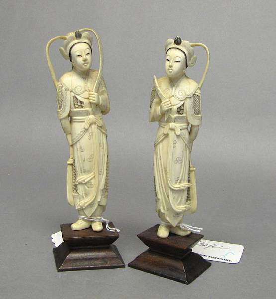 Appraisal: Ivory and Bone Carvings With wood stands one figure with