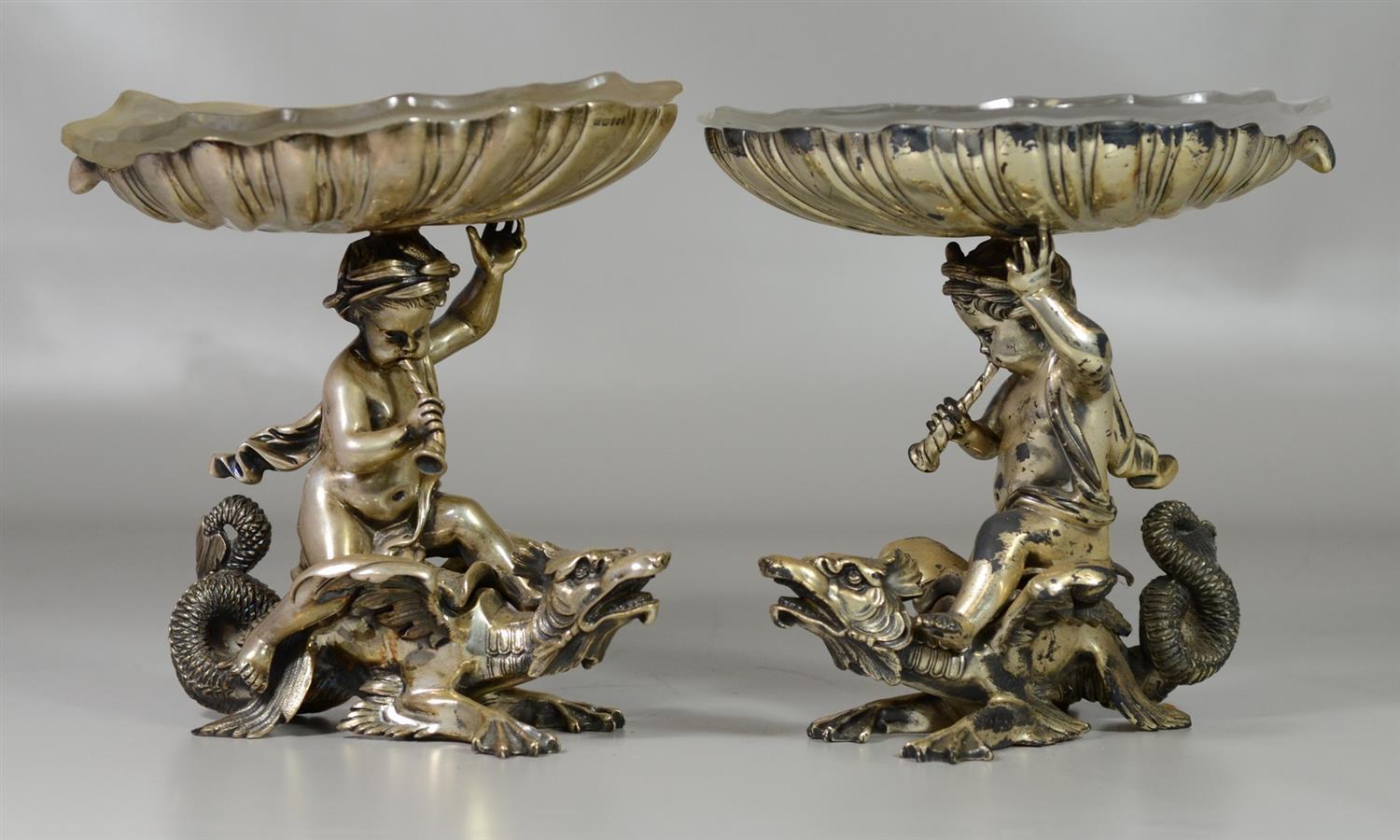 Appraisal: Pair of English Silverplated Compotes cherubs astride winged dragons marked