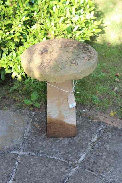 Appraisal: A SMALL SANDSTONE STADDLE STONE the circular top on a