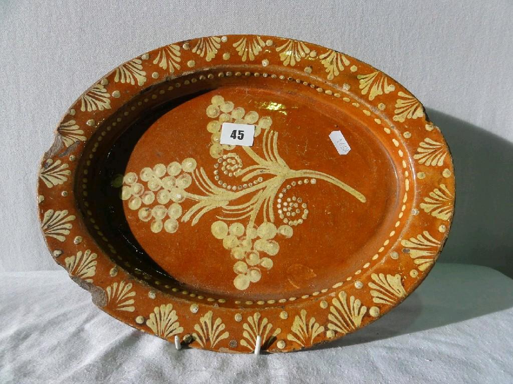 Appraisal: A th century slipware dish of oval form with painted