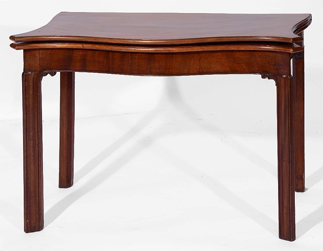 Appraisal: A GEORGE III MAHOGANY SERPENTINE FOLD OVER TEA TABLE on