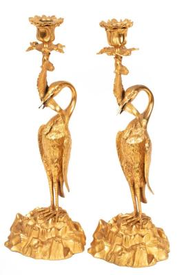 Appraisal: A pair of figured ormolu candlesticks each modeled with a