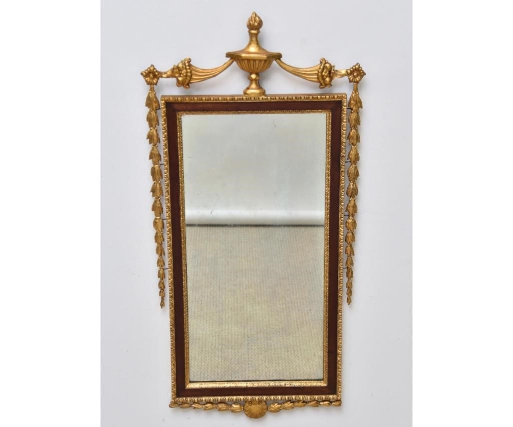 Appraisal: Sheraton style mahogany mirror with gilt urn finials and shell