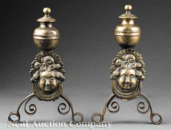 Appraisal: A Pair of French Mask-Decorated Brass and Iron Andirons th