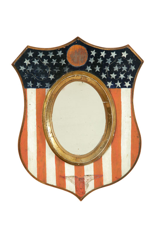 Appraisal: DECORATED SHIELD MIRROR American late th century walnut In the