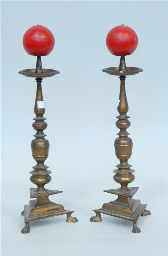 Appraisal: PAIR OF BRASS CANDLE PRICKS Having turned decoration and paw