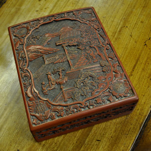 Appraisal: Chinese carved red lacquer box cover decorated with figures on